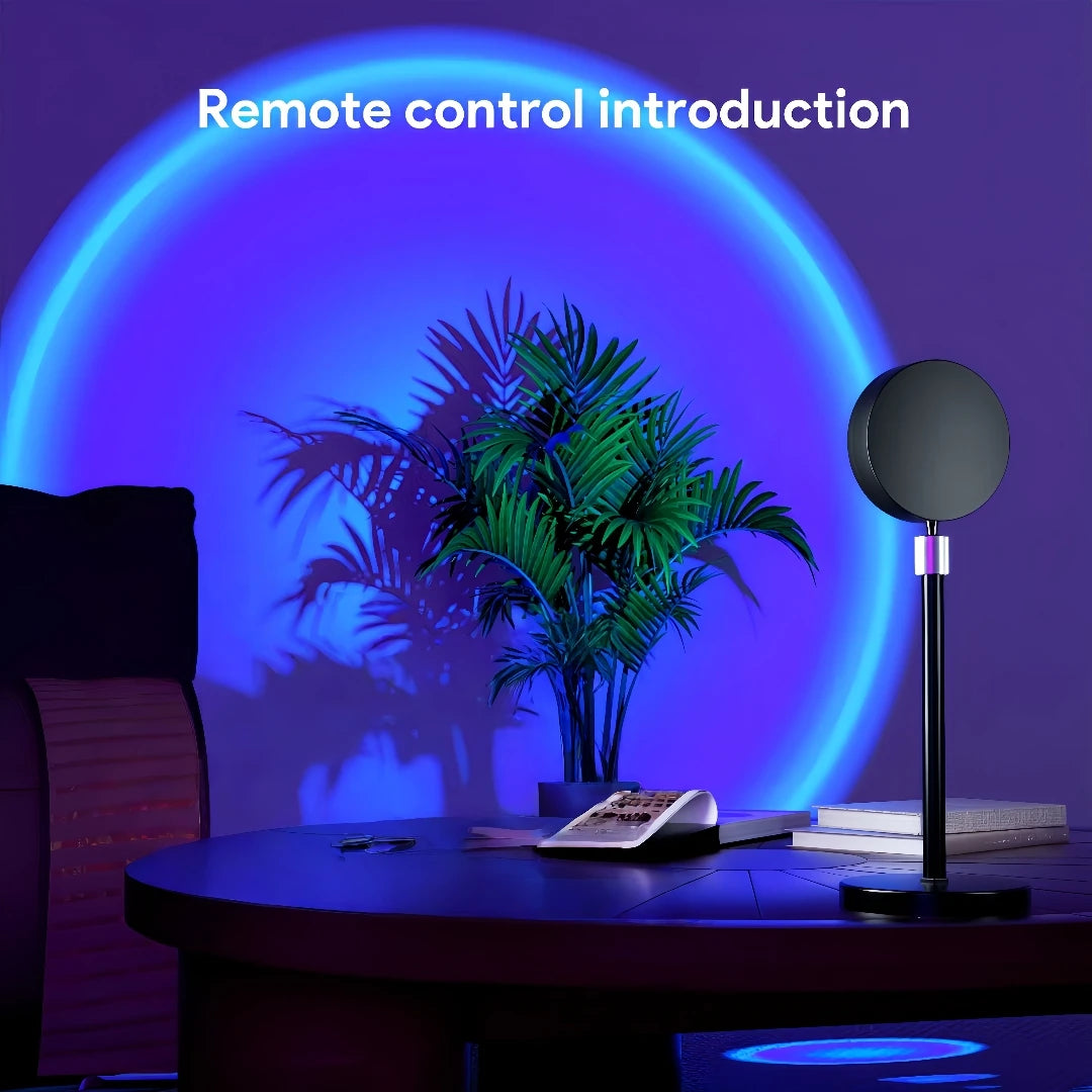 Table with remote control, lamp, and books under a blue circular light projection.